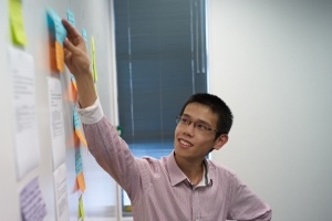 Matthew Wong updating a Kanban board on an agile software development project